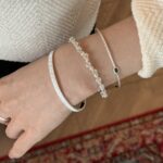 Multi-layered silver bracelet featuring vertical stripes and blue zirconia stones - Image 2